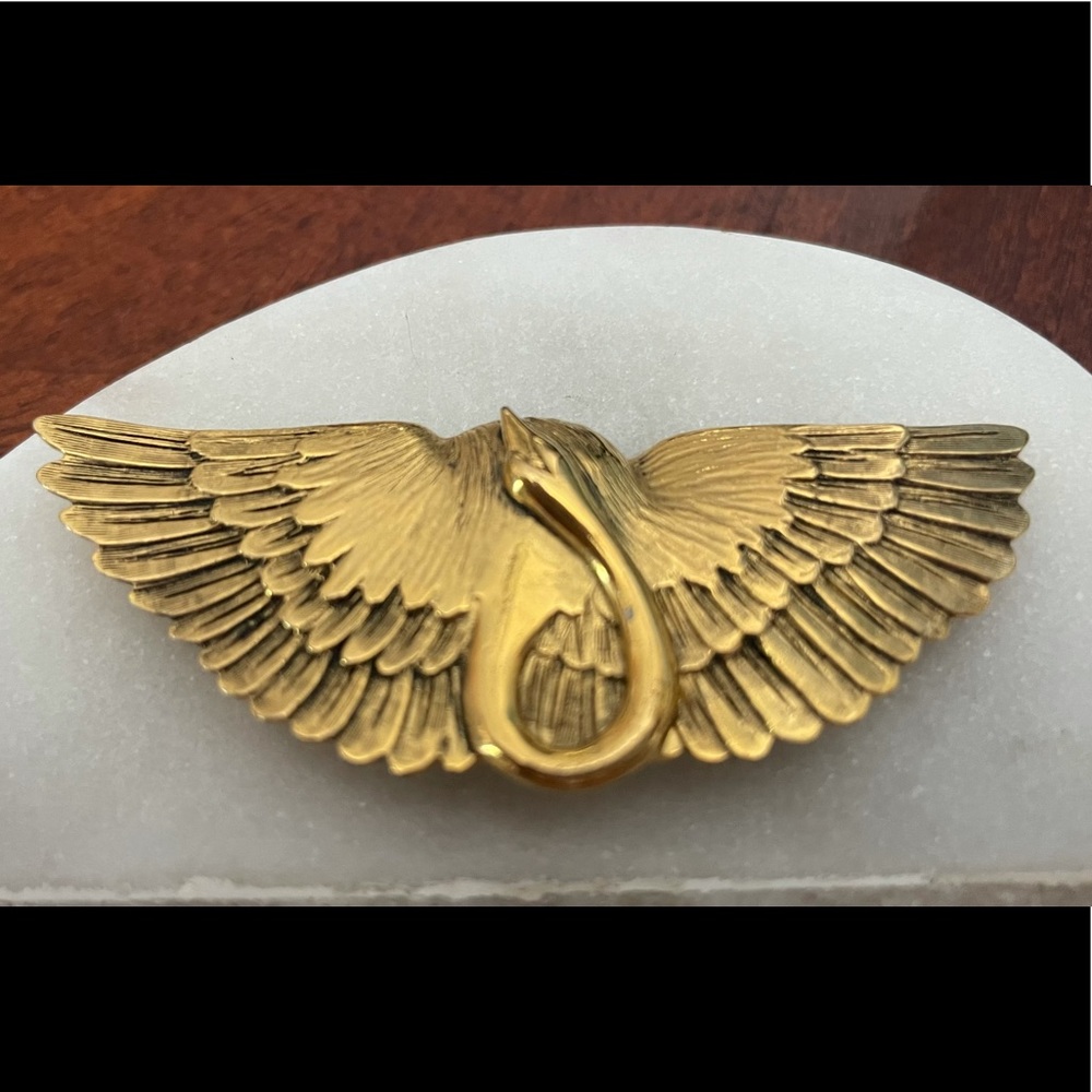 A gold tone swan pin signed MFA.Museum of Fine Art